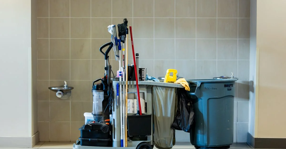 Une collection complète d'outils de nettoyage professionnels sur un chariot dans un environnement intérieur.