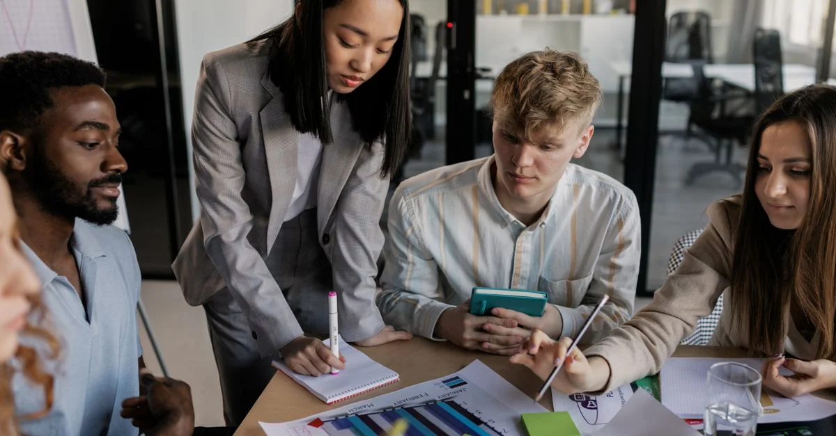 Jeunes professionnels engagés dans une session de planification stratégique, illustrant le travail d'équipe et la collaboration.
