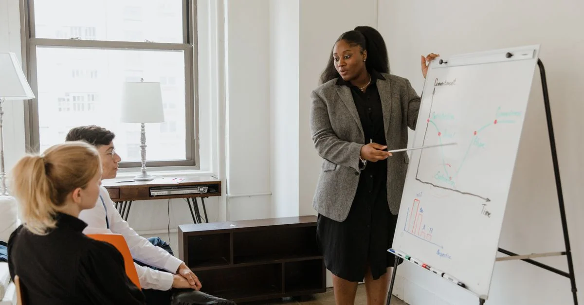 Une femme professionnelle dirige une présentation dans une salle de conférence de bureau, favorisant la diversité au travail.